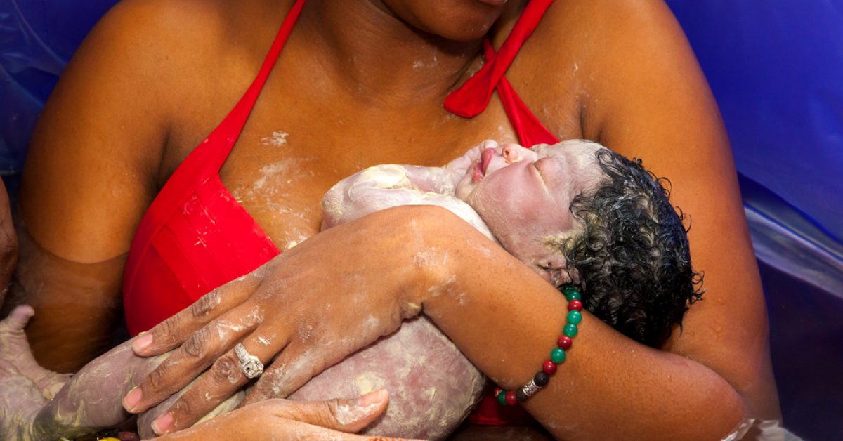 An,African,American,Mother,Cradles,Her,Newborn,Daughter,After,Giving